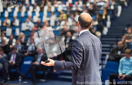 Image of Public speaker giving talk at Business Event.