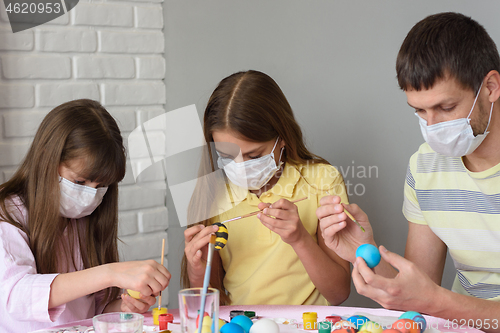 Image of Ill children and dad paint Easter eggs for Easter