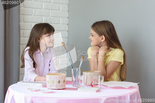 Image of Children sit at the table and wait for the start of the Easter celebration.