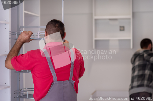 Image of workers installing a new kitchen