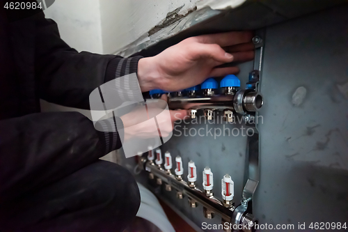 Image of engineer checking technical data of heating system