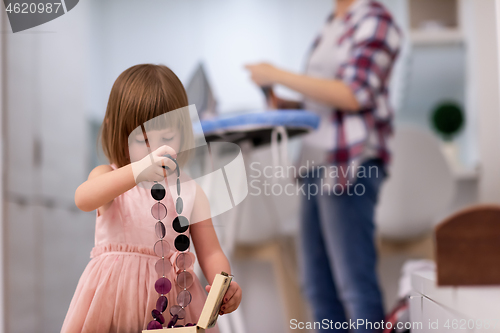 Image of mother and daughter spending time together at home