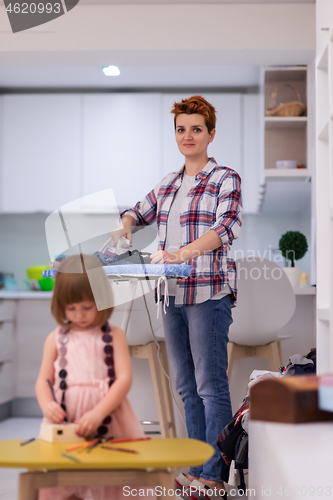 Image of mother and daughter spending time together at home