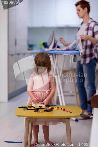 Image of mother and daughter spending time together at home