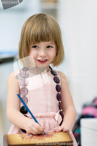 Image of little girl painting jewelry box