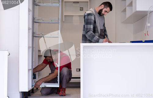 Image of workers installing a new kitchen