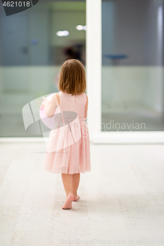 Image of cute little girl playing with balloons