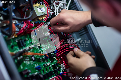 Image of electrician engineer working with electric cable wires