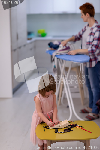 Image of mother and daughter spending time together at home