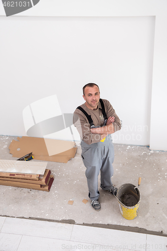 Image of worker installing the ceramic wood effect tiles on the floor