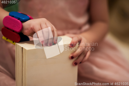 Image of little girl enjoying while playing with mother\'s jewelry