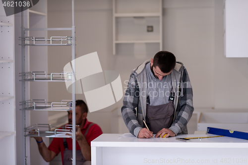 Image of workers installing a new kitchen