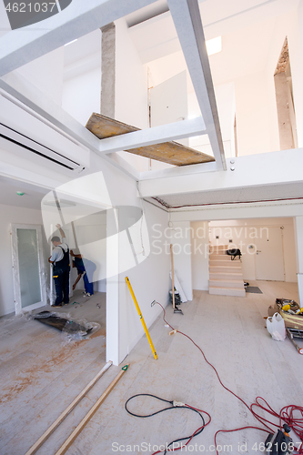 Image of carpenters installing glass door with a wooden frame