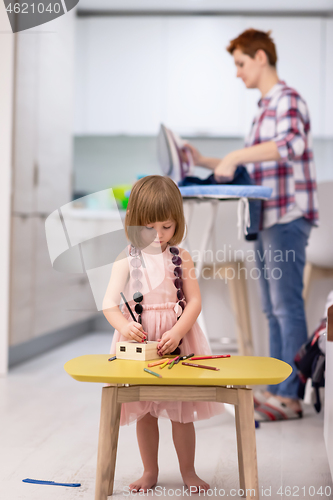 Image of mother and daughter spending time together at home