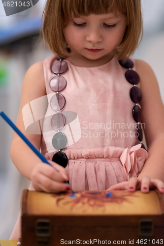 Image of little girl painting jewelry box