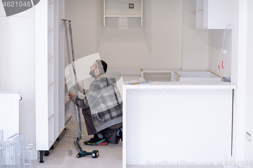 Image of worker installing a new kitchen