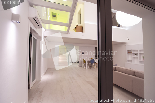 Image of outside view trough window on two level apartment interior