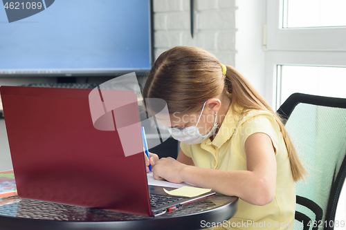 Image of The girl performs the teacher\'s assignment received online