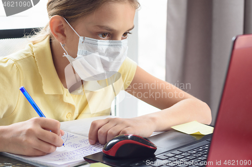 Image of Girl in a protective mask remotely watch training services