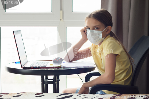 Image of The girl is tired and is remotely studying in quarantine