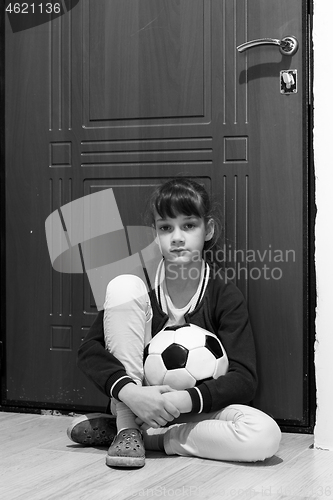 Image of Girl locked up with a ball at the front door