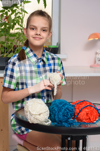 Image of Girl learns to knit soft toys while being in quarantine at home