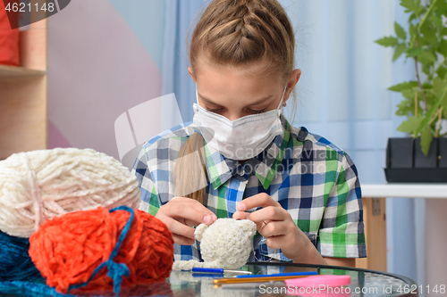 Image of Teenager embroidering a house in self-isolation mode