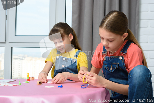 Image of Two girls play games at the table