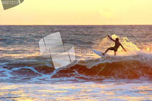 Image of Surfer at sunset, silhouette