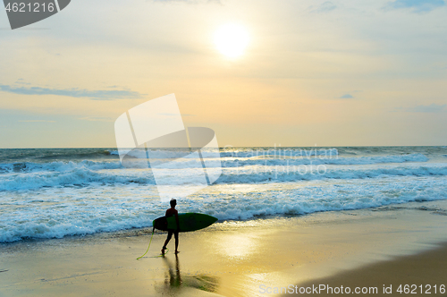 Image of Young surfer on the beach