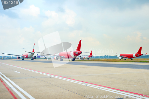 Image of Airport runway full of planes