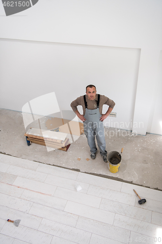 Image of worker installing the ceramic wood effect tiles on the floor