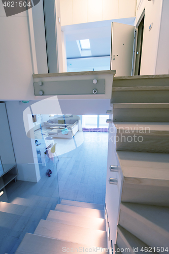 Image of stylish interior with wooden stairs