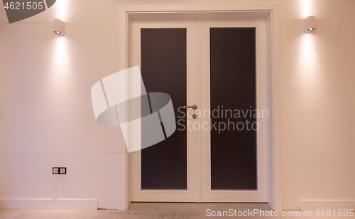 Image of double glass door with white wooden frame