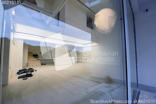 Image of outside view trough window on two level apartment interior