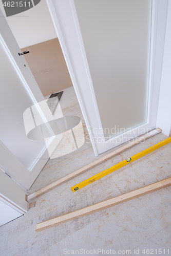 Image of double glass door with white wooden frame