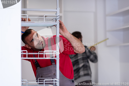 Image of workers installing a new kitchen