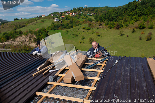 Image of Construction worker installing a new roof