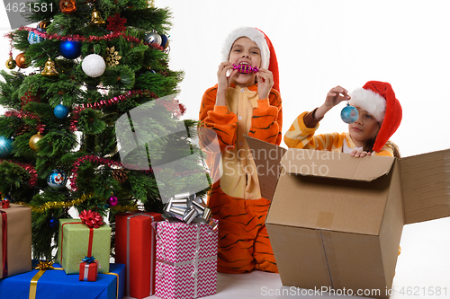 Image of Two girls fooling around and looking at Christmas toys