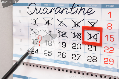 Image of The pen indicates Monday on the calendar with a question mark, previous weeks are crossed out due to quarantine