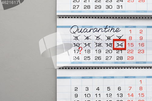 Image of Calendar on a white wall with the inscription quarantine and crossed out days of the week