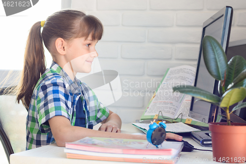 Image of The girl is studying remotely at home, using online learning