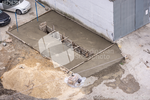 Image of Inspection pit freshly concrete and fenced with formwork for machine repair