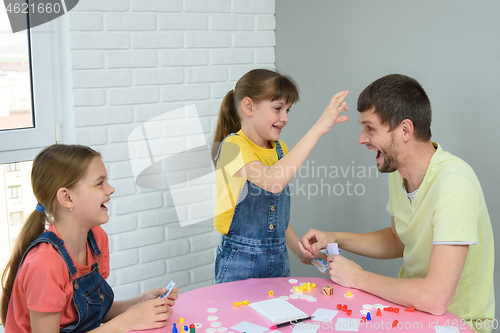 Image of Daughter is going to punch dad in the forehead for a loss in a board game