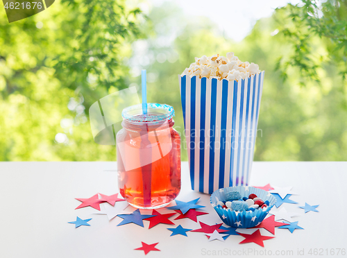 Image of drink and popcorn with candies on independence day