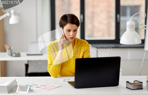 Image of ui designer calling on smartphone at office