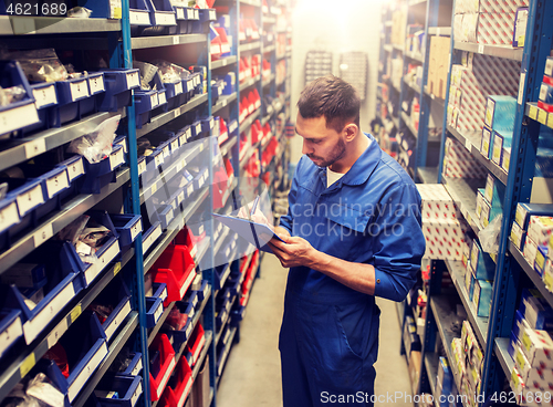 Image of auto mechanic or smith with tablet pc at workshop