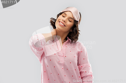 Image of happy young woman in pajama and eye sleeping mask