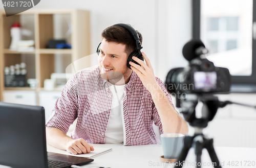 Image of male blogger with headphones videoblogging