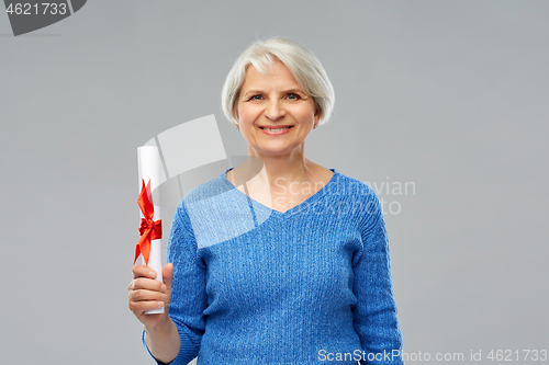 Image of happy senior graduate student woman with diploma